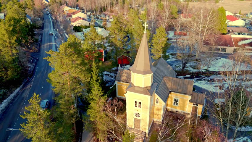 Aerial view of the historic Vahto wooden church in a green spring landscape, Finland.