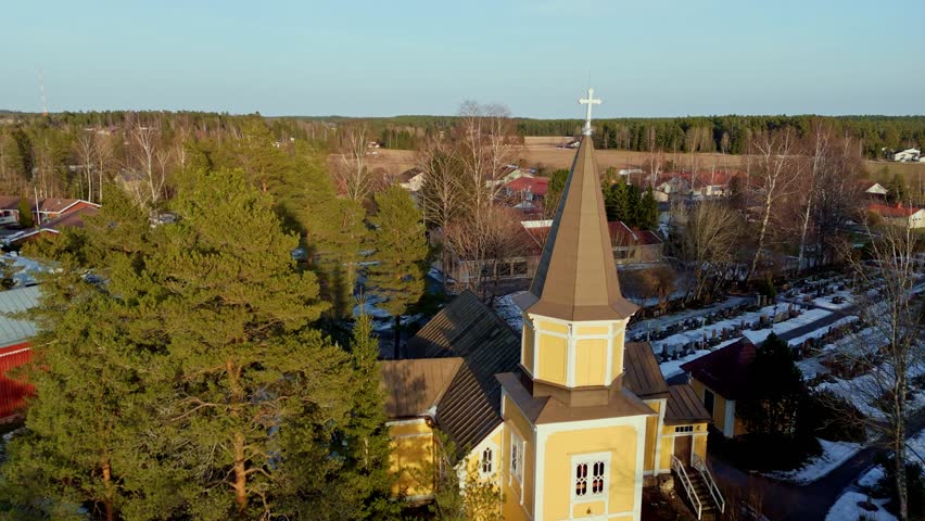 Aerial view of the historic Vahto wooden church in a green spring landscape, Finland.