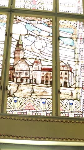 Vertical editorial shot of the biblical figure stained glass art at the Novi Sad Synagogue.