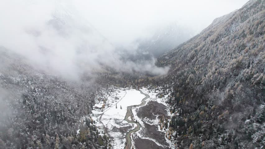 Drone view of landscape of Changping valley in Siguniang Mountain, or Four Sisters Mountain in Sichuan, China in snowing day. 4k real time footage b roll shot travel concept.