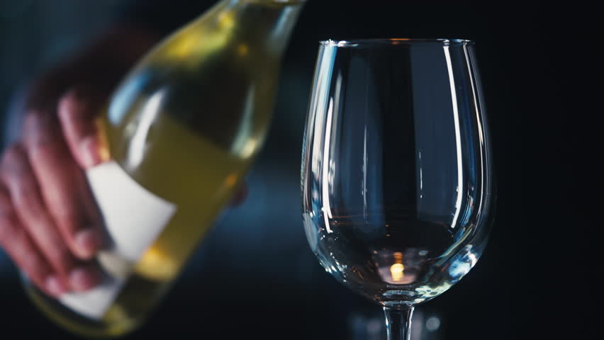 Pouring white wine into a glass