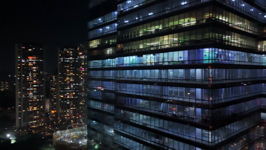 Aerial night skyline of Mumbai with illuminated skyscrapers and traffic