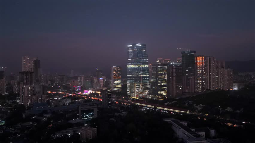 Aerial night skyline of Mumbai with illuminated skyscrapers and traffic