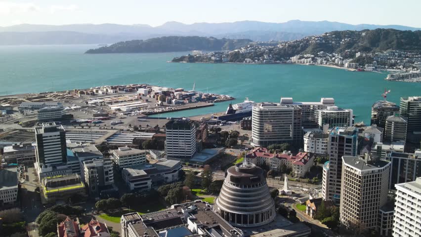 Beehive and New Zealand Parliament buildings with seaside drone panorama. Wellington
