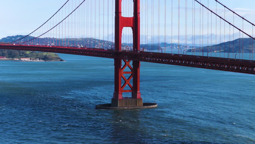Vehicles Driving Over The Golden Gate Bridge On A Clear Day In San Francisco, California, USA. Aerial Shot