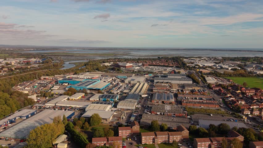 Portsmouth UK drone flight over predominantly commercial are close to the harbour with views out to sea on bright sunny day,detailed and varied aerial view