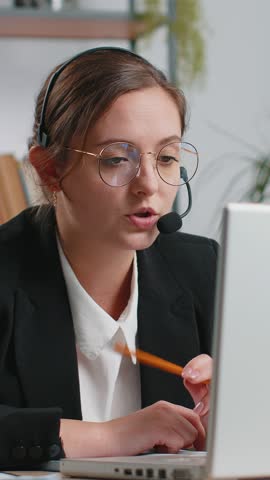 Caucasian business woman working on laptop wearing headset freelance worker call center, support service operator helpline having pleasant talk with client or colleague communication support at office