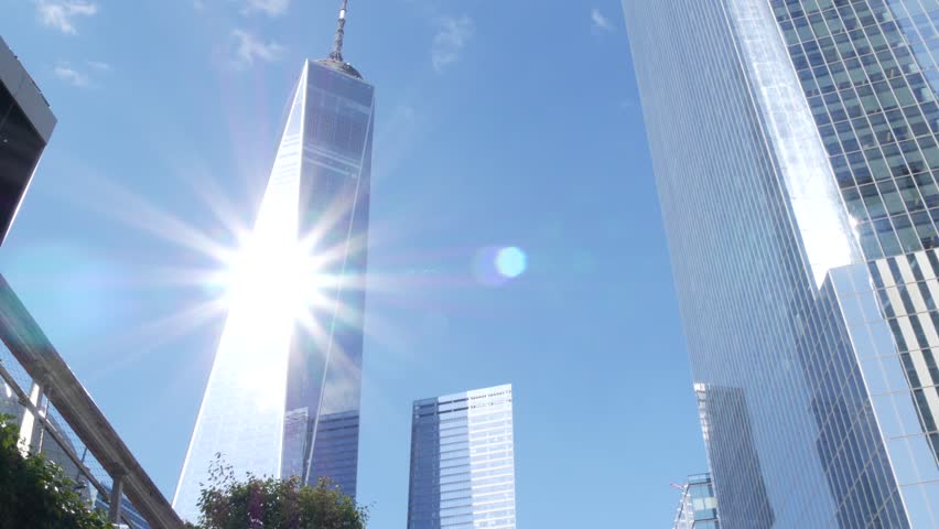 New York City Manhattan Downtown Financial District, United States of America. World Trade Center skyscraper, tower building in FiDi. Low angle from Liberty street. Modern business center. Sun rays.