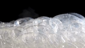 A mesmerizing view of transparent bubbles clustered together, creating stunning reflections and unique patterns, highlighting their delicate nature and intricate details. - Powered by Shutterstock - Get 15% off with code: PIKWIZARD15