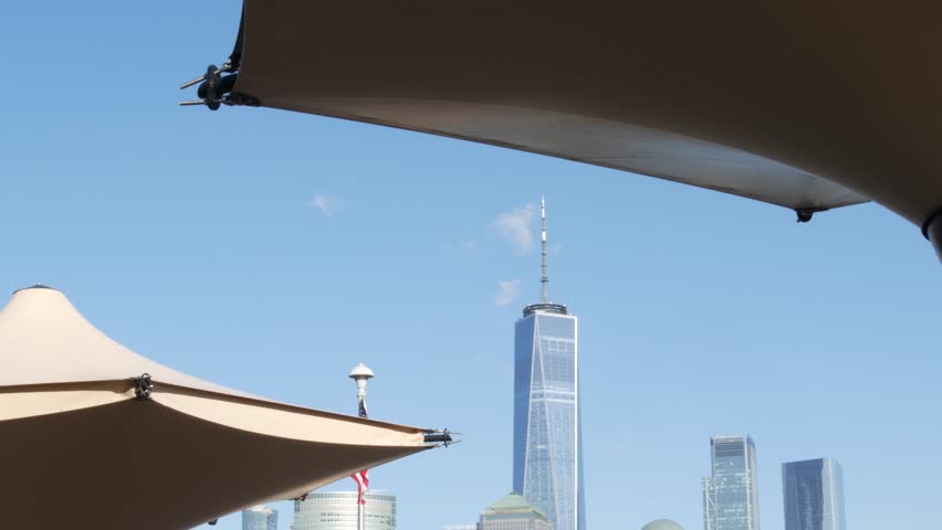 New York City Manhattan downtown financial district skyline, New Jersey Exchange Place, United States. Urban cityscape with skyscraper buildings, World Trade Center. J Owen Grundy park, Paulus Hook.