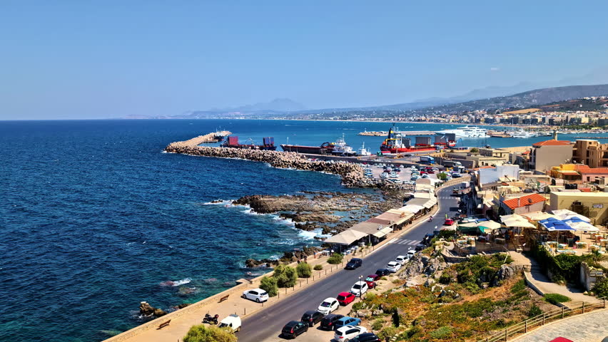 Panoramic View Of Coastal Town Of Rethymno, As Seen From Fortezza In Crete, Greece. high angle, panning shot