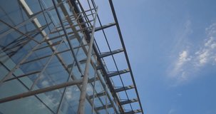 A building with scaffolding on the side and a blue sky in the background. The sky is clear and bright, and the building is tall and imposing - Powered by Shutterstock - Get 15% off with code: PIKWIZARD15