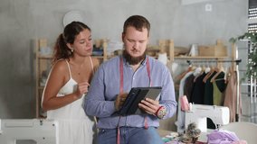 Tailor and client collaborating on custom design in sewing studio. High quality 4k footage - Powered by Shutterstock - Get 15% off with code: PIKWIZARD15