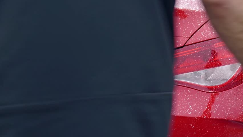 Applying Snow Foam to the rear of a red sports car coupe - Mercedes Benz close up