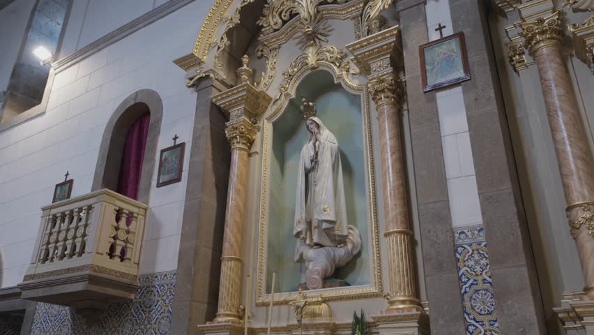 Interior church altar with Virgin Mary statue framed by ornate columns