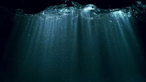 Dark Blue Ocean Surface Seen from Underwater , Super Slow Motion . Abstract Waves and Rays of Sunlight Shining Through - Powered by Shutterstock - Get 15% off with code: PIKWIZARD15