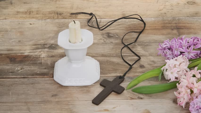 Female hand with Wooden cross necklace with spring hyacinths, Easter, faith, and spring themes, resurrection and new life, Religious still life and flowers