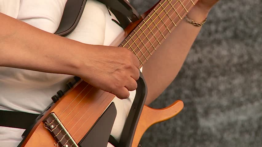 a guitarist plays a string guitar in the summer outdoors