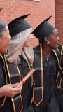 Group of excited multiracial female students in graduation gowns and caps celebrating together. Young women smiling and laughing at the university - Powered by Shutterstock - Get 15% off with code: PIKWIZARD15