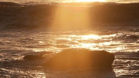 A breaking ocean wave backlit by the sun during sunset. Filmed in Costa da Caparica, Portugal, the visuals highlight nature and the movement of water. - Powered by Shutterstock - Get 15% off with code: PIKWIZARD15