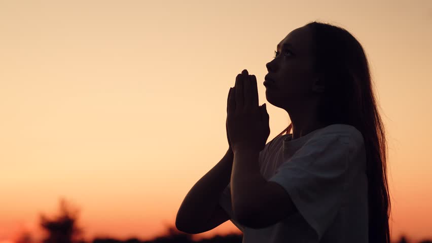 Silhouette woman girl praying, man believing God, woman girl asking forgiveness sunset, looking up sky, praying, giving thanks, asking help, reflection and meditation, youthful innocence spirituality