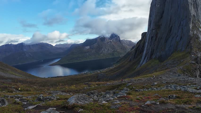 People hiking towards Segla Mountain in Norway