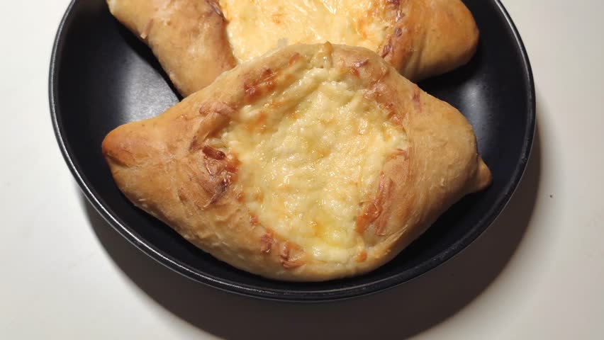 Homemade raw khachapuri bread with rich cheese filling. 