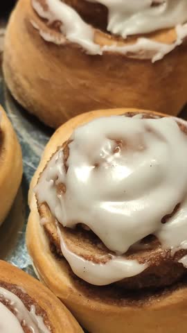 Golden cinnamon rolls arranged on a plate. Fresh bakery.