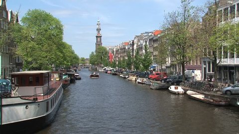AMSTERDAM - CIRCA 2013: Pedalo and boat in Amsterdam canal