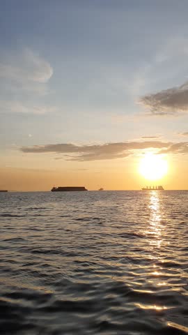 the sun is visible over the vast ocean