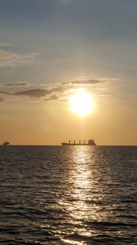 the sun is visible over the vast ocean