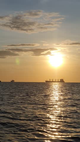the sun is visible over the vast ocean