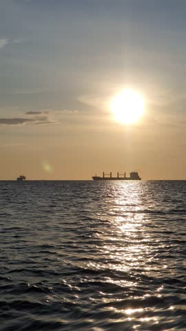 the sun is visible over the vast ocean