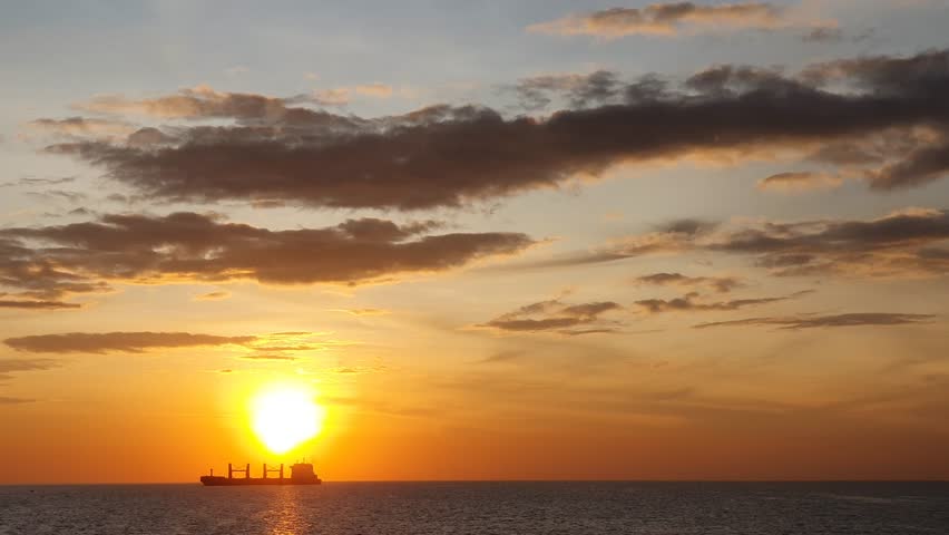 the sun is visible over the vast ocean