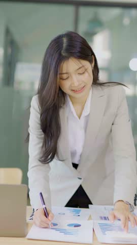 Female accountant working on financial investment on calculator, calculation, analysis of company income.