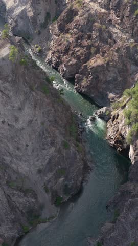 Majestic wild river carves its path through a stunning rocky canyon in British Columbia, Canada.