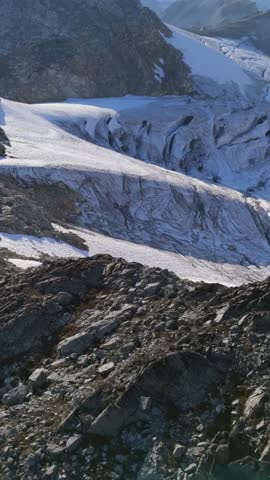 Aerial view showcasing a stunning glacier and rugged snow-capped peaks in the Canadian wilderness.