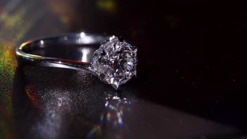 Shimmering Diamond Ring is Shown in Deep Dramatic Macro Composition. Highlighting Its Precise Facets and Polished Metal Finish. Timeless Symbol of Elegance, Luxury and Masterful Beauty Craft Design 4k