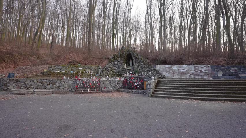 Small pilgrimage shrine with candles and stone grotto in Marianka, Slovakia. Peaceful religious place in forest known as one of the oldest pilgrimage sites near Bratislava.