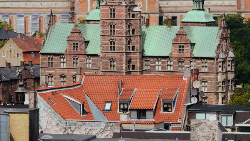 Rosenborg Castle facade towering above traditional red tile roofs in Copenhagen, Denmark