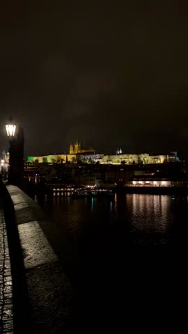 View of the sights of Prague, Czech Republic at night. Charles Bridge, St. Nicholas Church, Prague Castle.