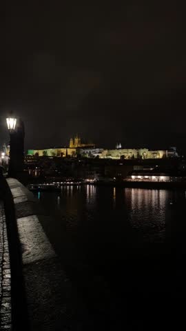 View of the sights of Prague, Czech Republic at night. Charles Bridge, St. Nicholas Church, Prague Castle.