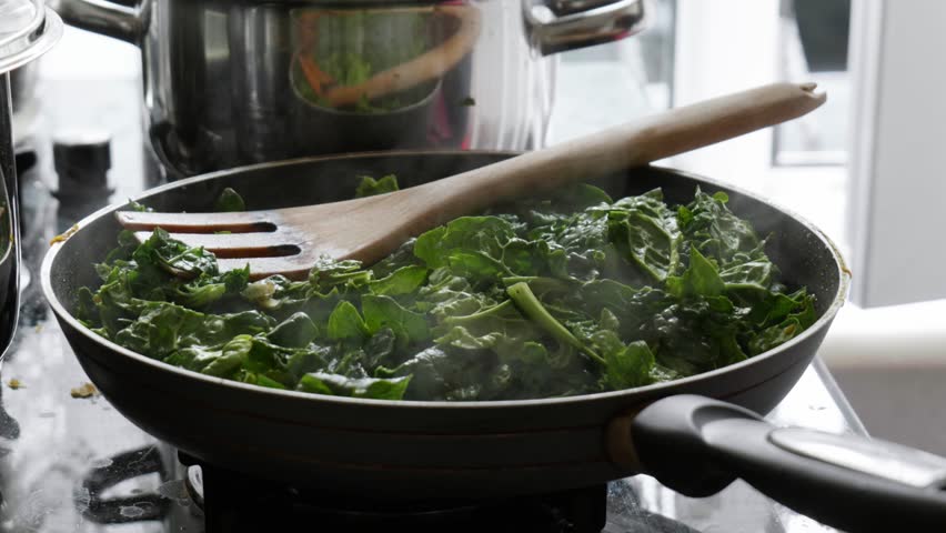 Sprinkling Salt over Sauteing Spinach in Slow Motion