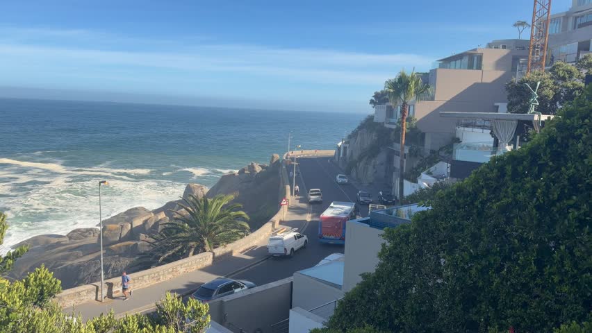 A view from above a street of a busy road and a coast of an ocean in Cape Town