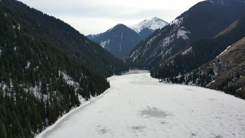 Aerial view of the picturesque Kolsai Lake in a winter mountain landscape