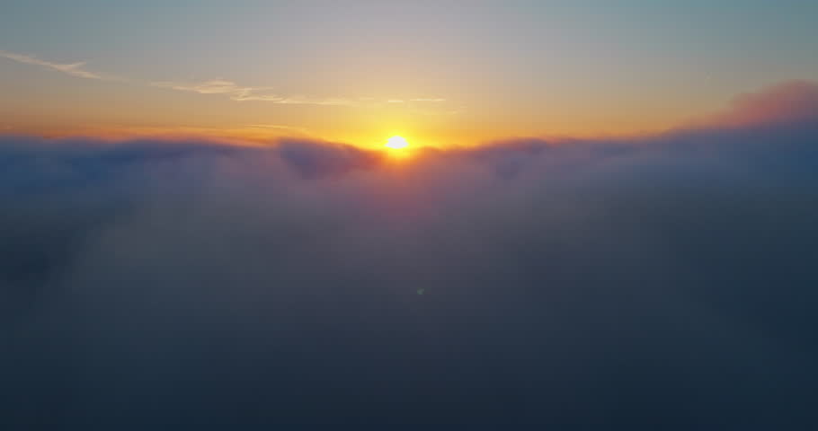 Sunset above clouds aerial landscape. Scenic drone shot bright sun disk over golden cloud formations. High altitude natural beauty travel destination heaven nature background.