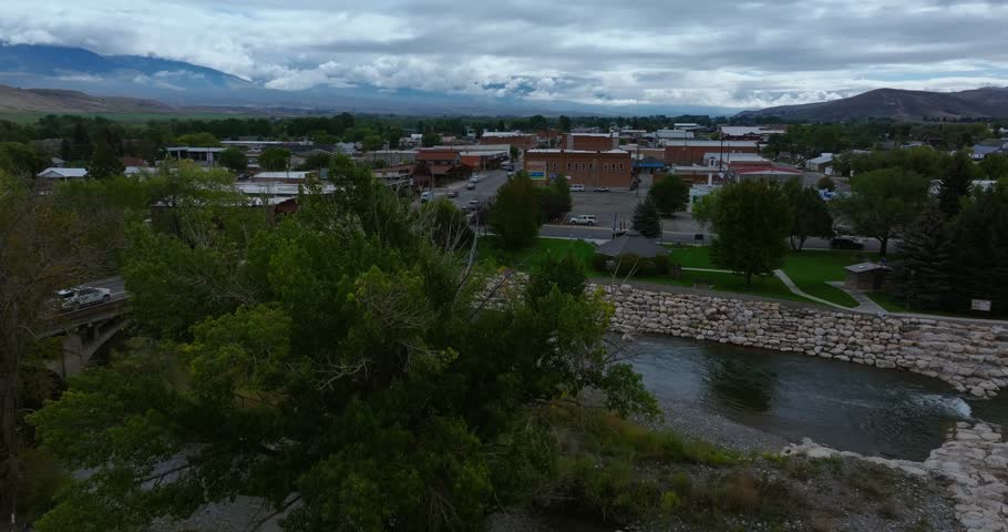 Riverbank and bridge leading into Salmon Idaho with mountains beyond