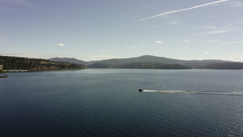 Drone shot of a powerboat racing across Lake Coeur d