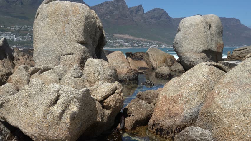 Rock pools between big granite beach rocks along a rocky coast