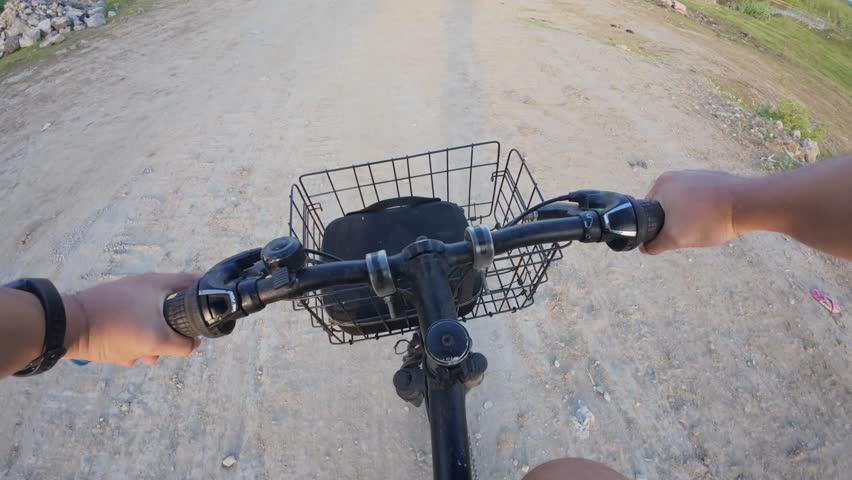 Riding A Bicycle On A Dirt Road